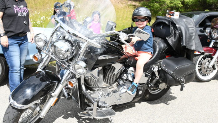 Kellen Harper Federiko sitting on a motorbike. [Photo credit | Karen Powell]